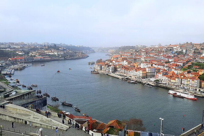 Porto Heritage Night Tour With Fado Show And Dinner Included - Porto’s nighttime sights from a private-style car